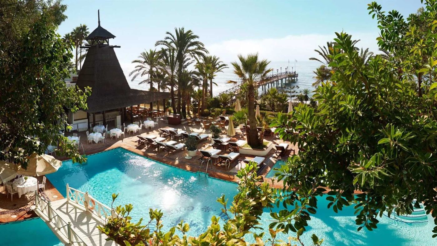 Sample photo: a resort pool among palms seen from above